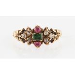 A Victorian emerald, ruby and diamond ring, set centrally with an emerald cut emerald, flanked to