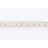 A topaz line bracelet, set with 22 round cut colourless topaz, stamped 375, length approx. 19.5cm.