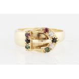 A buckle design ring, set with ruby, sapphire and emerald accents, indistinctly stamped, ring size