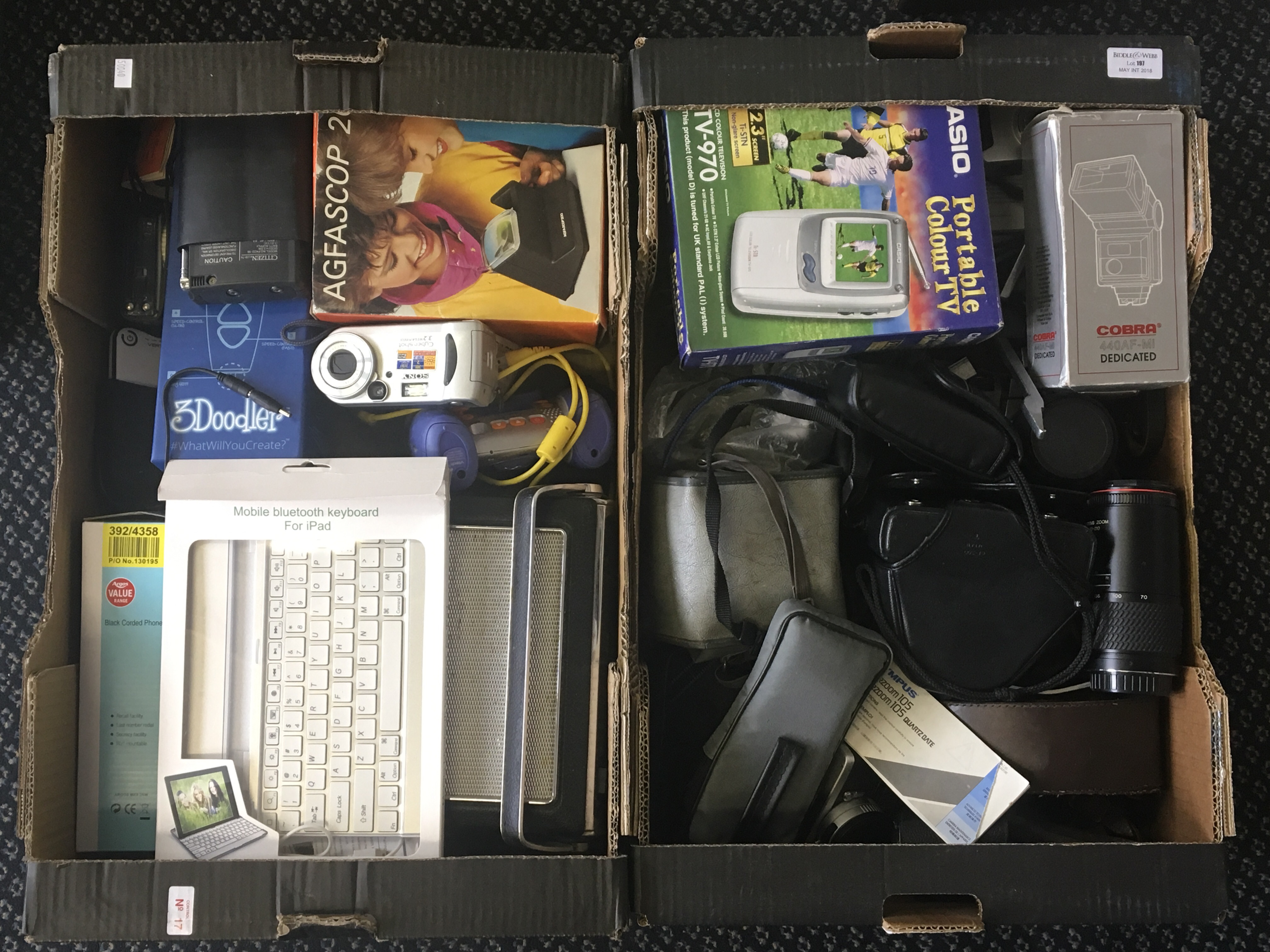 Two boxes of various camera accessories, a radio and various other electrical appliances.