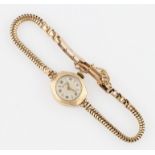 A ladies 9ct yellow gold cased Rotary wrist watch, the cream tone dial having alternating Arabic and