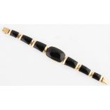 A black stone bracelet, with articulated links, clasp stamped K14, length approx. 19cm.