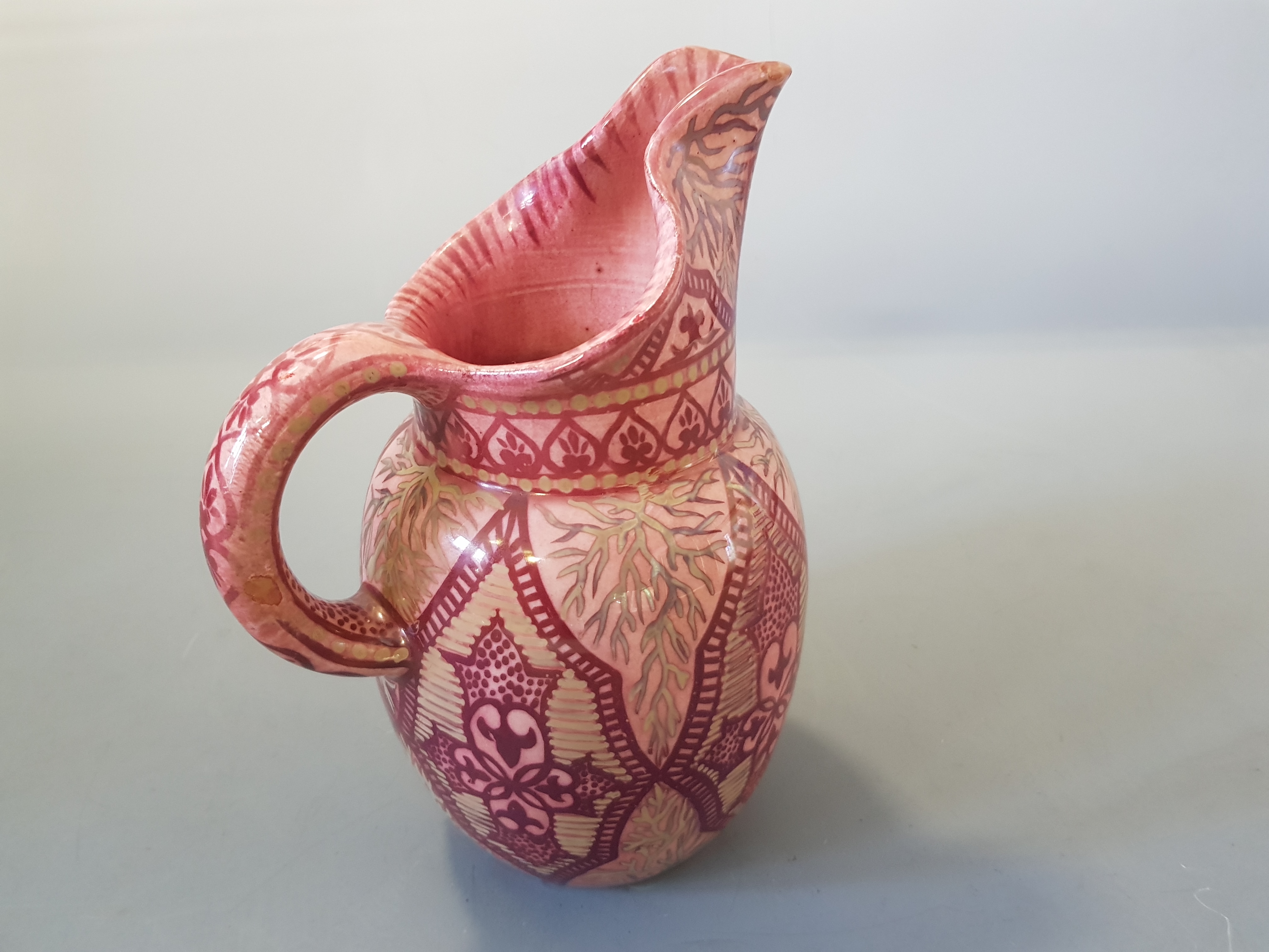 A pink and gold lustre jug marked to base, by L Castel Cannes Mont Chevalier, 21cm high.