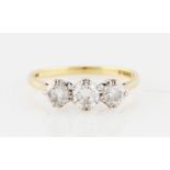 An 18ct yellow gold three stone diamond ring, set with three graduated round brilliant cut diamonds,