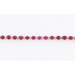 A contemporary ruby and diamond line bracelet, set with 27 sapphires, each measuring approx.