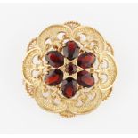 A 9ct yellow gold garnet brooch / pendant, the scroll edge design set with six oval cut garnets,