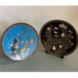 A circular cloisonne wall plate with bird and floral decoration on black background 30.5 cm, and