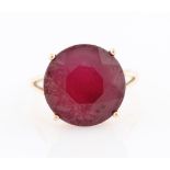 A 9ct yellow gold treated ruby ring, set with a round cut treated ruby (possibly glass filled),