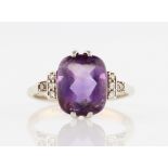 An amethyst and diamond ring, set with a mixed cut amethyst, measuring approx. 10x8mm, with