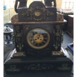 A large black mottled marble cased mantle clock, figure decoration to front.