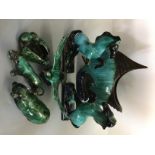 A collection of Blue Mountain animal figurines, depicting a fish, two rearing horses, an eagle in