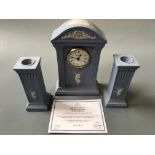 A pale blue Jasper pair of Wedgwood millenium candlestick and matching clock.