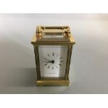 A Mappin and Webb brass cased carriage clock, and bevel glass panels.