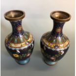 A pair of cloisonne vases with floral decoration, approximately 24 cm.