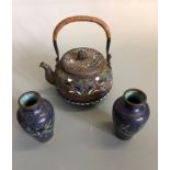 A cloisonne tea pot, multi- coloured with lid, approximately 8 cm high, together with a small pair