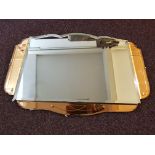 An Art Deco style beveled edged wall mirror with three amber glass panels.