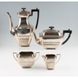 A four piece silver tea set, comprising a tea pot, water jug, sugar bowl and milk jug, all featuring