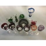 A collection of Bohemian coloured cut glassware, including three pairs of goblets and variously