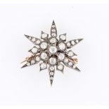 A Victorian diamond star brooch with pendant fitting, set with 31 variously size old cut diamonds,