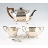 A three piece silver tea set, comprising a tea pot, a sugar bowl and a milk jug, all of octagonal