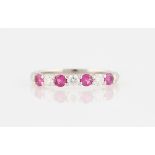 A Tiffany & Co. Embrace pink sapphire and diamond half eternity ring, set with four round cut pink