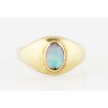 A single stone opal ring, set with an oval cut opal cabochon, set in unmarked yellow metal, ring