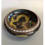 A circular cloisonne bowl decorated with dragons, on outside and inside, approximately 21 cm.