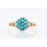 A turquoise ring, the circular design head set with circular turquoise cabochons to split design