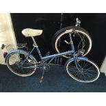 A Raleigh unisex bicycle with 4 spare tyres