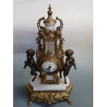 An Italian brass marble ornate mantle clock, bronzed cherub figures either side on claw feet.