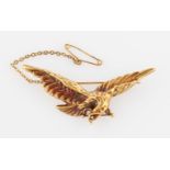 A French eagle brooch, depicting eagle in flight with baroque pearl dropper suspended from beak,