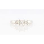 A diamond three stone ring, set with three graduated princess cut diamonds, total diamond weight