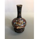 A bulbous shaped cloisonne vase, decorated with birds, dragon and florals on wood stand,