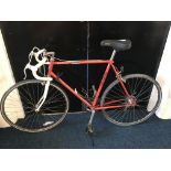 A gents Emmelle red framed, drop handlebar racing bicycle
