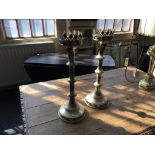 A pair of gothic style, silver finished candlestick holders with crown design to top.