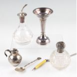 A collection of hallmarked silverware, to include lidded jars, a weighted bud vase, a pepperette,