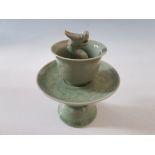 A celadon dragon trick cup on stand, in the Quinlong Emperor style.