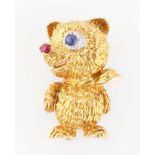 A 1960s Cartier 18ct yellow gold novelty bear brooch, designed as a bear wearing a neckerchief,