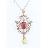 An Edwardian style pink tourmaline, peridot and diamond pendant, set with a central pink tourmaline,