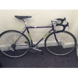 A gents purples framed Swinnerton racing bicycle with drop handlebar