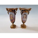 A pair of 19th Century porcelain, hand painted urns with gilt design, signed Max.