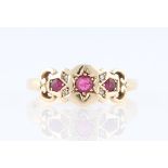 A modern early 20th Century style ruby and diamond ring, set with three graduated round cut rubies