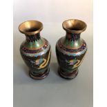 A pair of cloisonne vases decorated with dragons, approximately 23.5 cm, on wood stand.