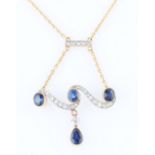 A sapphire and diamond necklet, the scroll design pendant set with three round cut sapphires