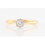 A diamond solitaire ring, set with a central round brilliant cut diamond, measuring approx. 0.