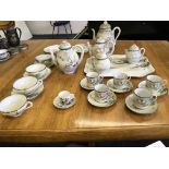 A selection of Japanese porcelain to include tea pots, saucers, cups etc, a serving tray etc.