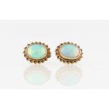 A pair of hallmarked 9ct yellow gold opal stud earrings, each set with an oval opal cabochon,