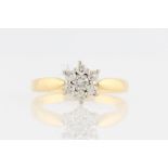 An 18ct yellow gold diamond cluster ring, set with a central round brilliant cut diamond