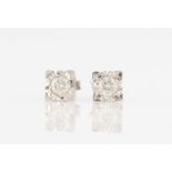 A pair of 9ct white gold diamond stud earrings, each set with a round brilliant cut diamond