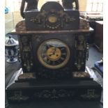 A large black mottled marble cased mantle clock, figure decoration to front. Height 52cm.